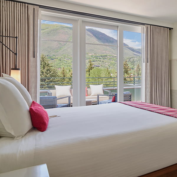 bed overlooking terrace and mountains