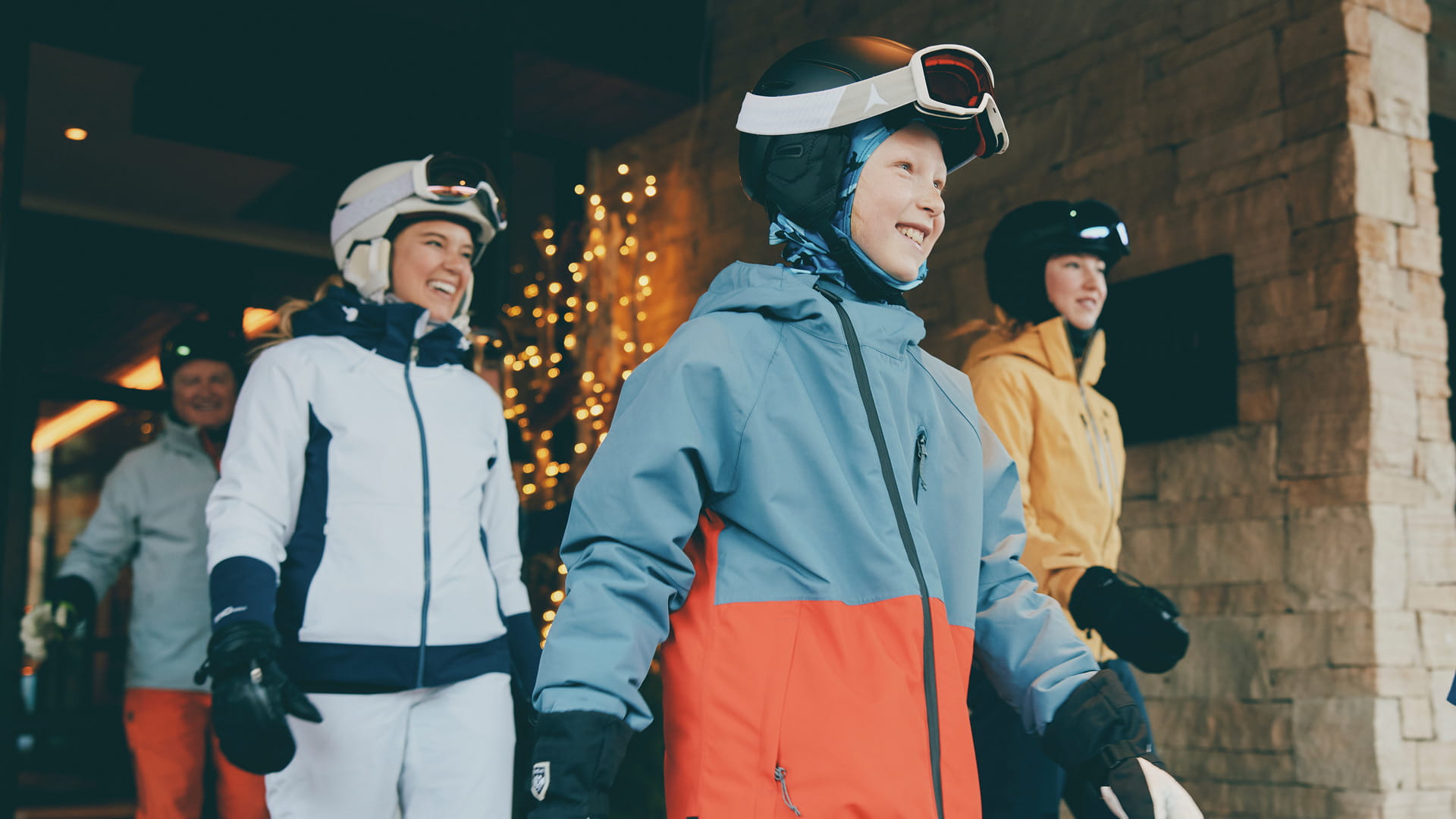 family of skiers walking out of hotel