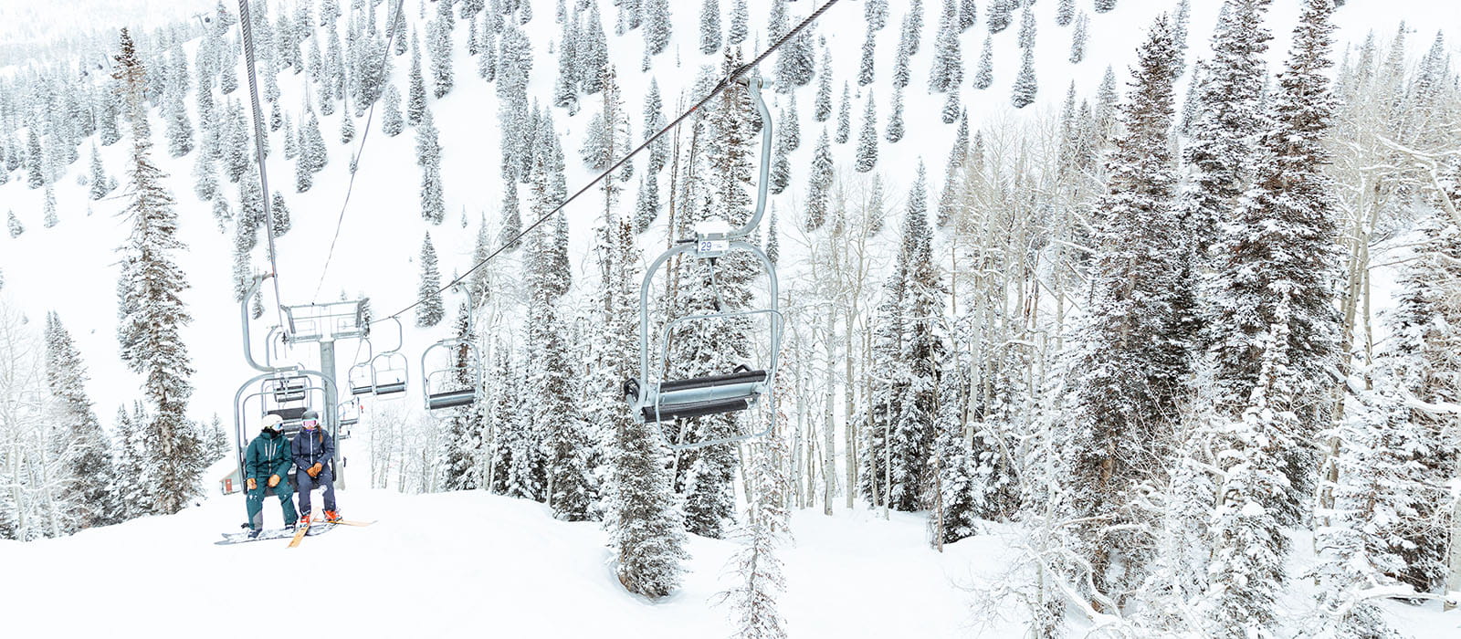 two skiers on a chairlift