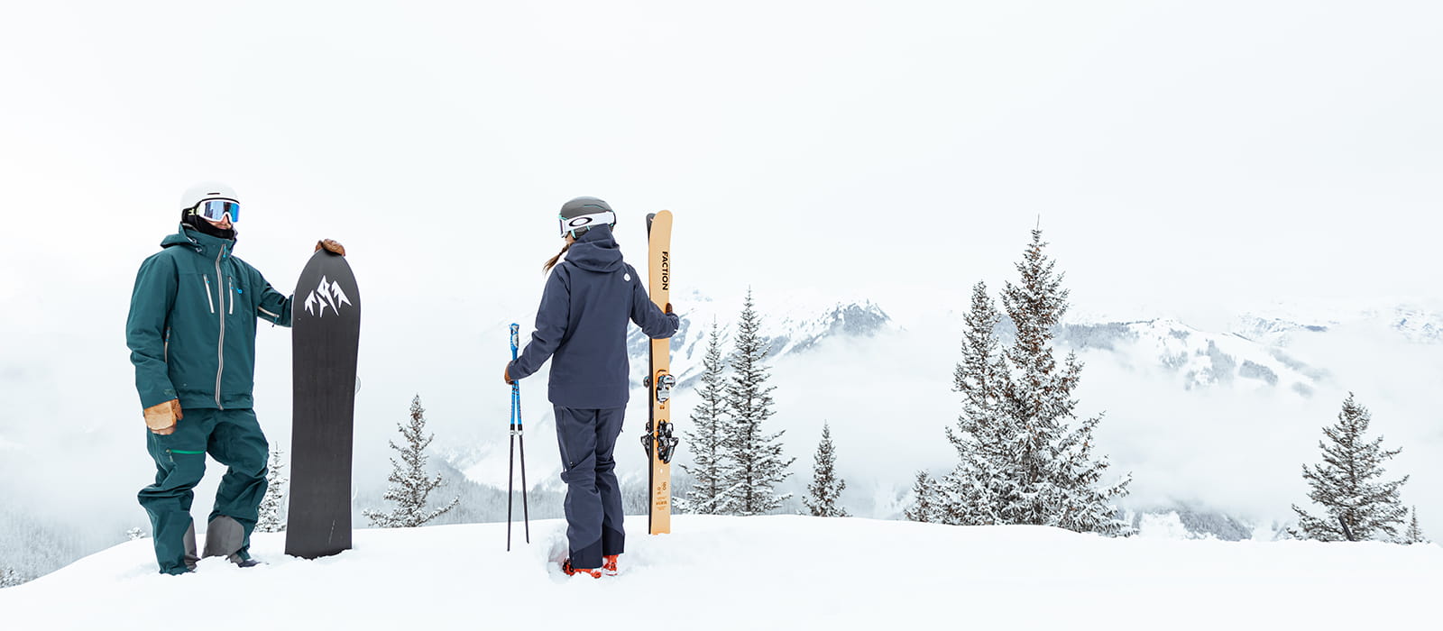 Snowboarder and skier at top of mountain