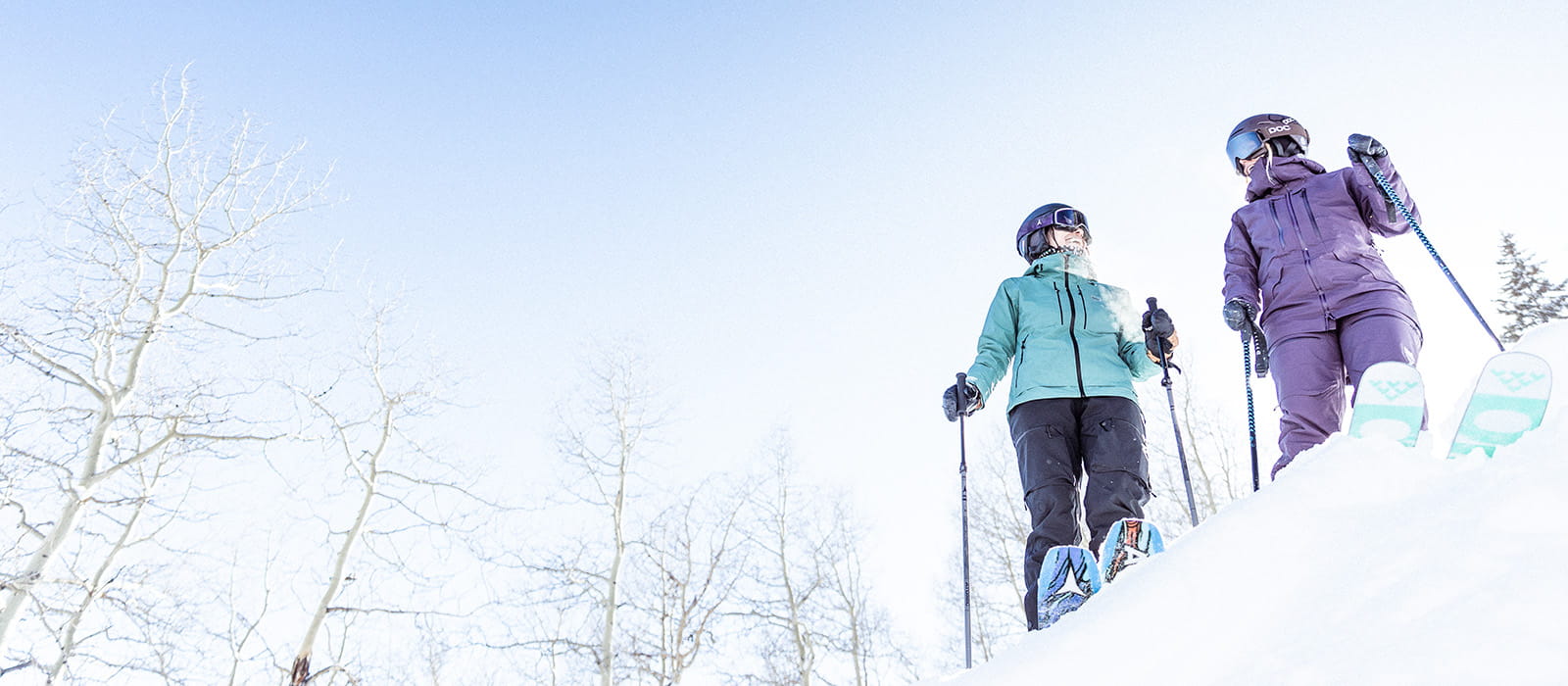 two skiers looking at each on mountain