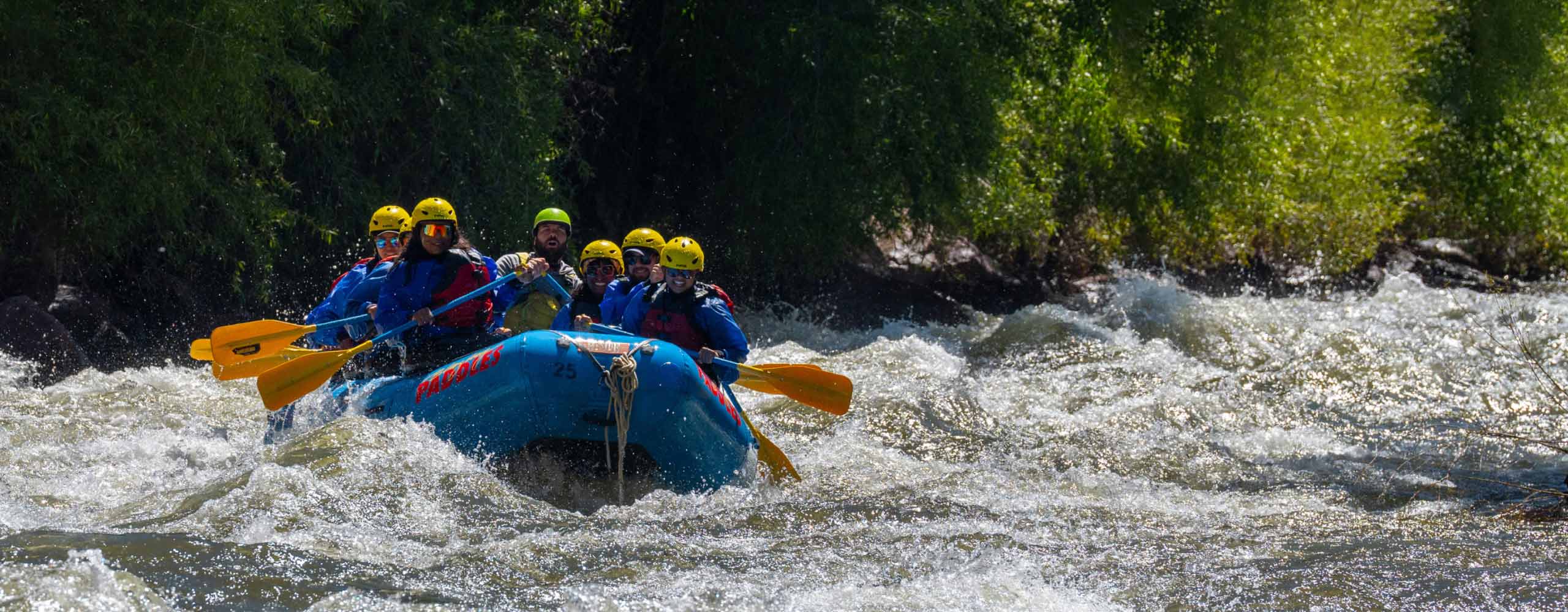 people rafting on river in mountains