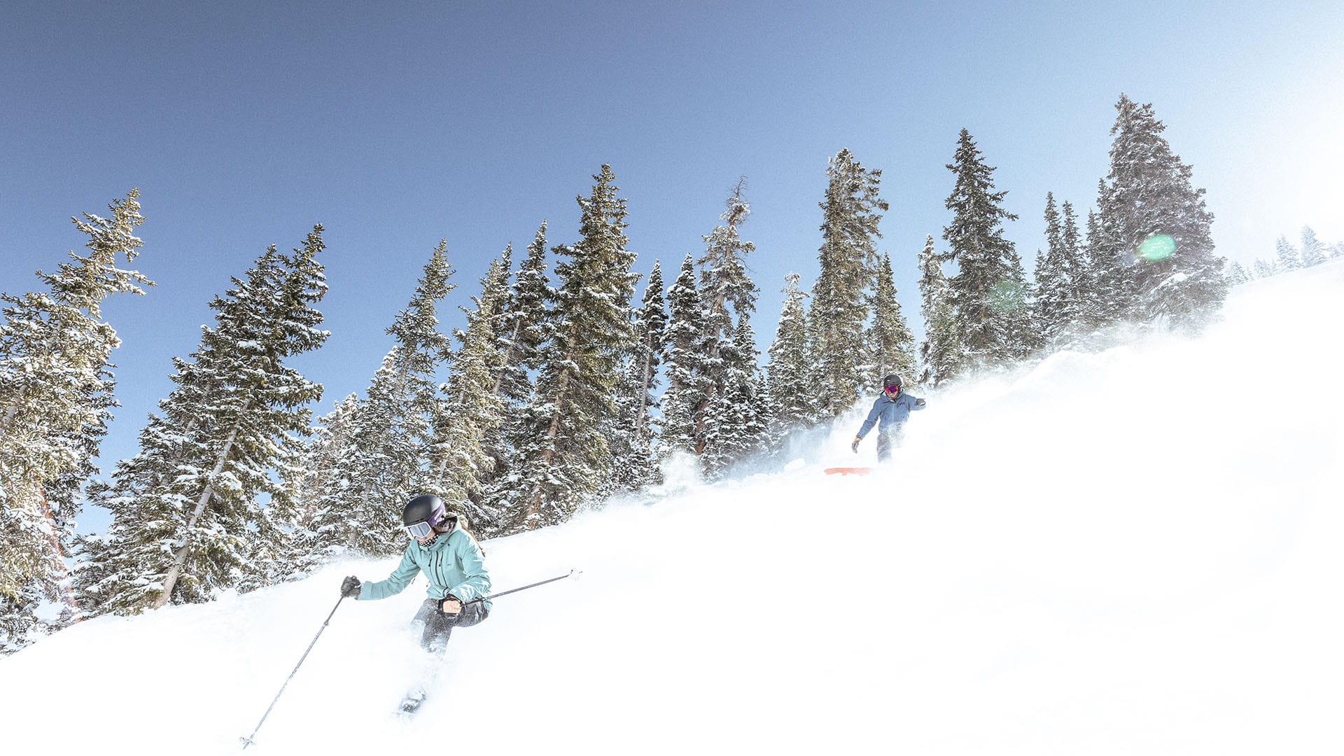 two skiers skiing mountain