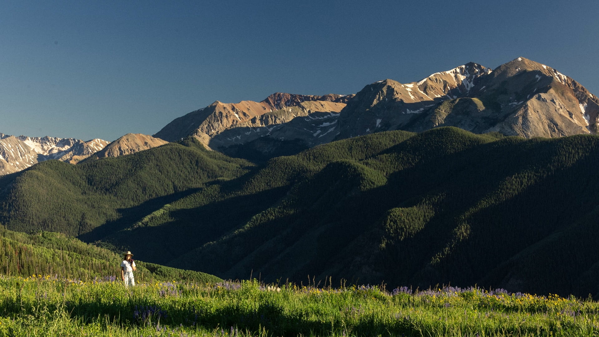 woman walking in front of mountains