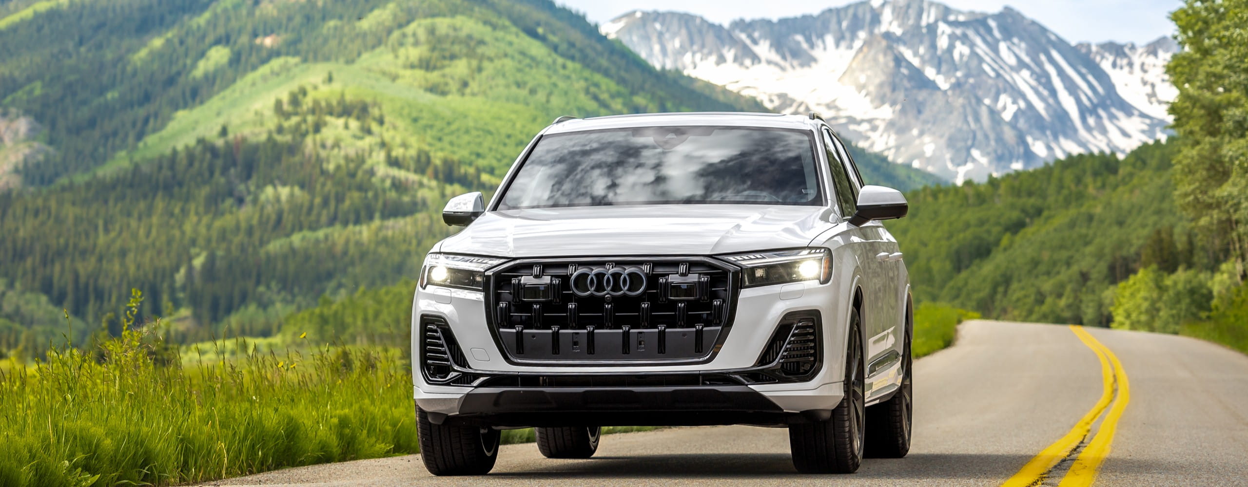 White Audi SUV car on a mountain road in Colorado