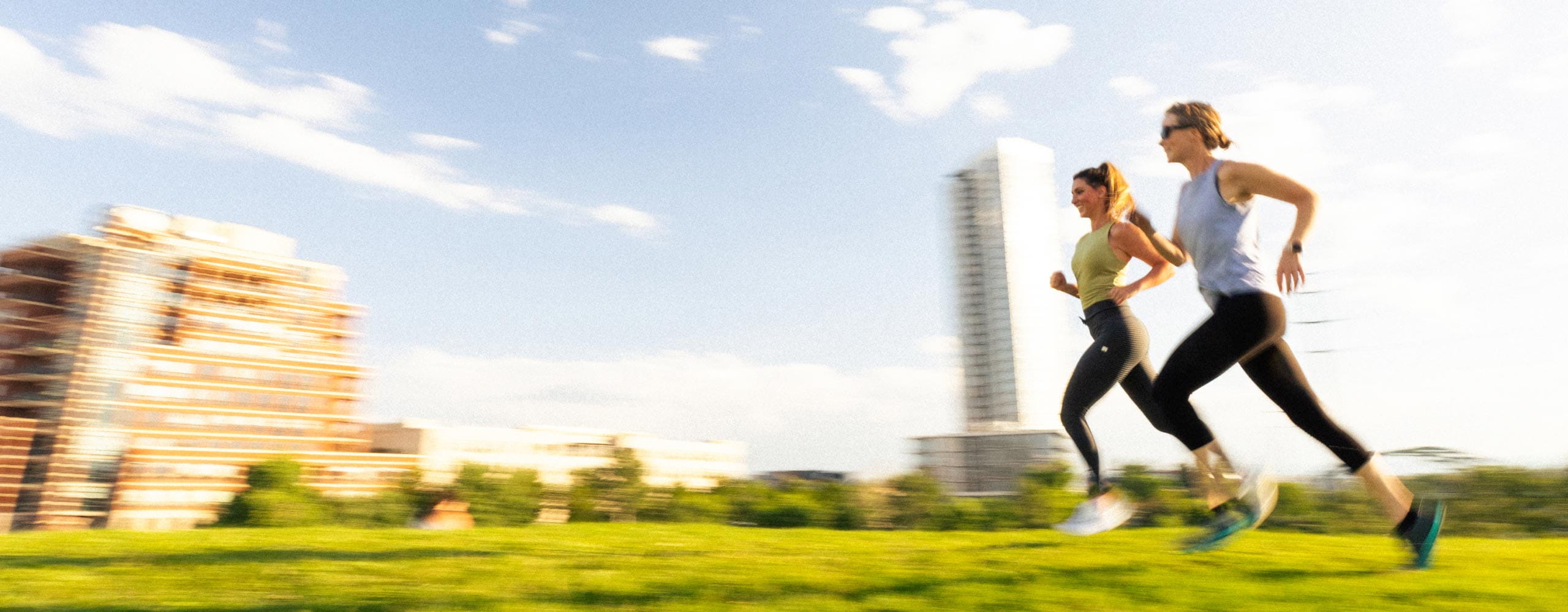 two people running through park in denver