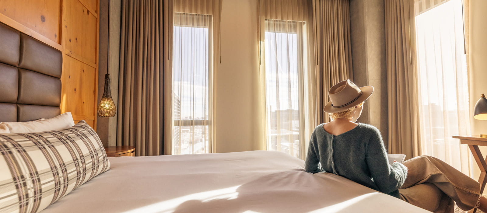 woman by bed in guestroom