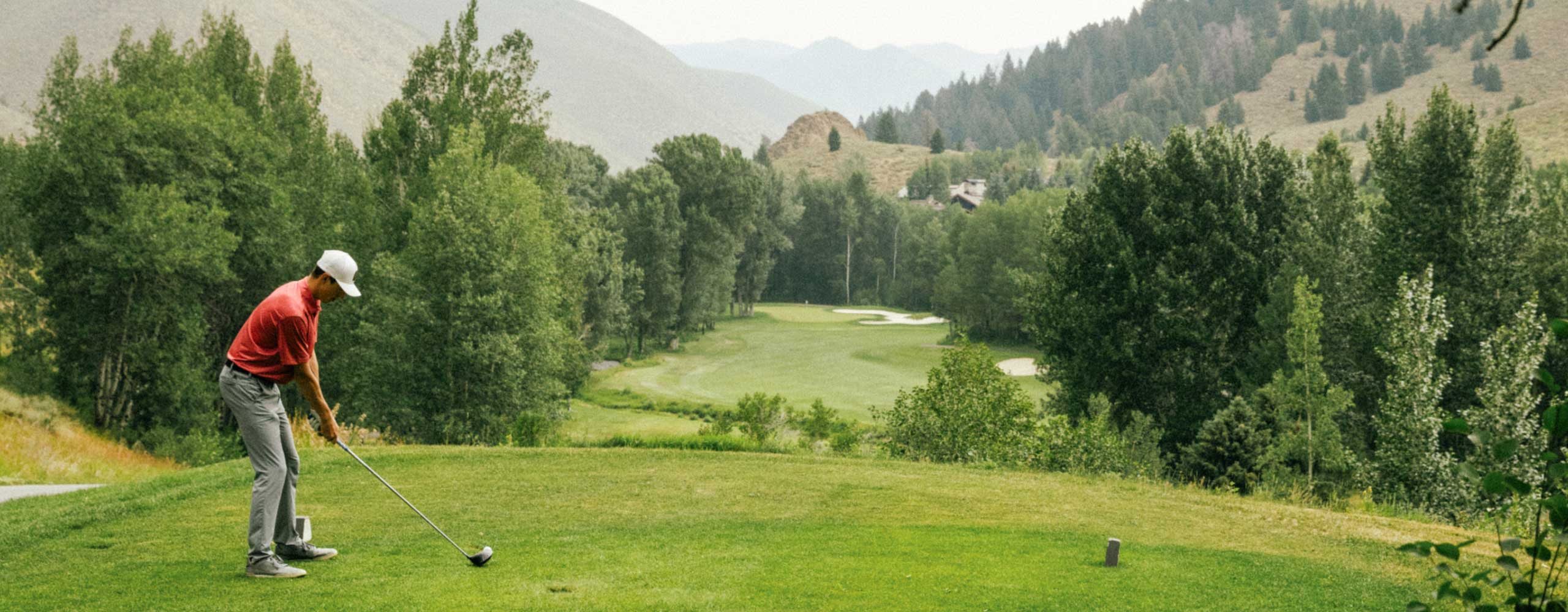 golfer golfing in mountains
