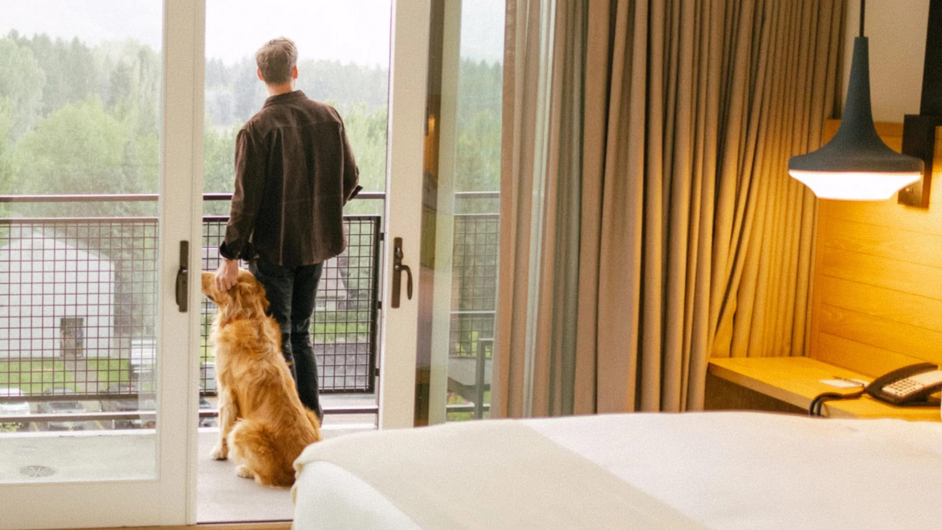 man and dog on guestroom balcony