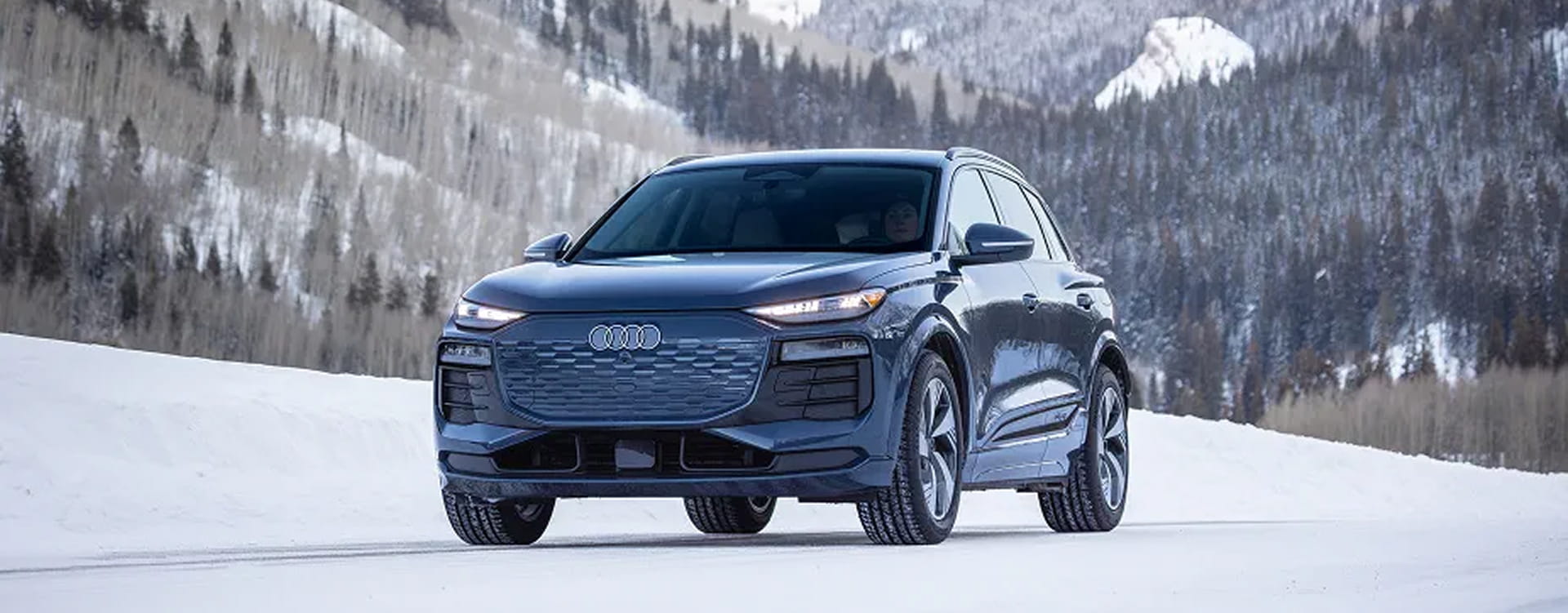 audi car in front of mountains in the winter