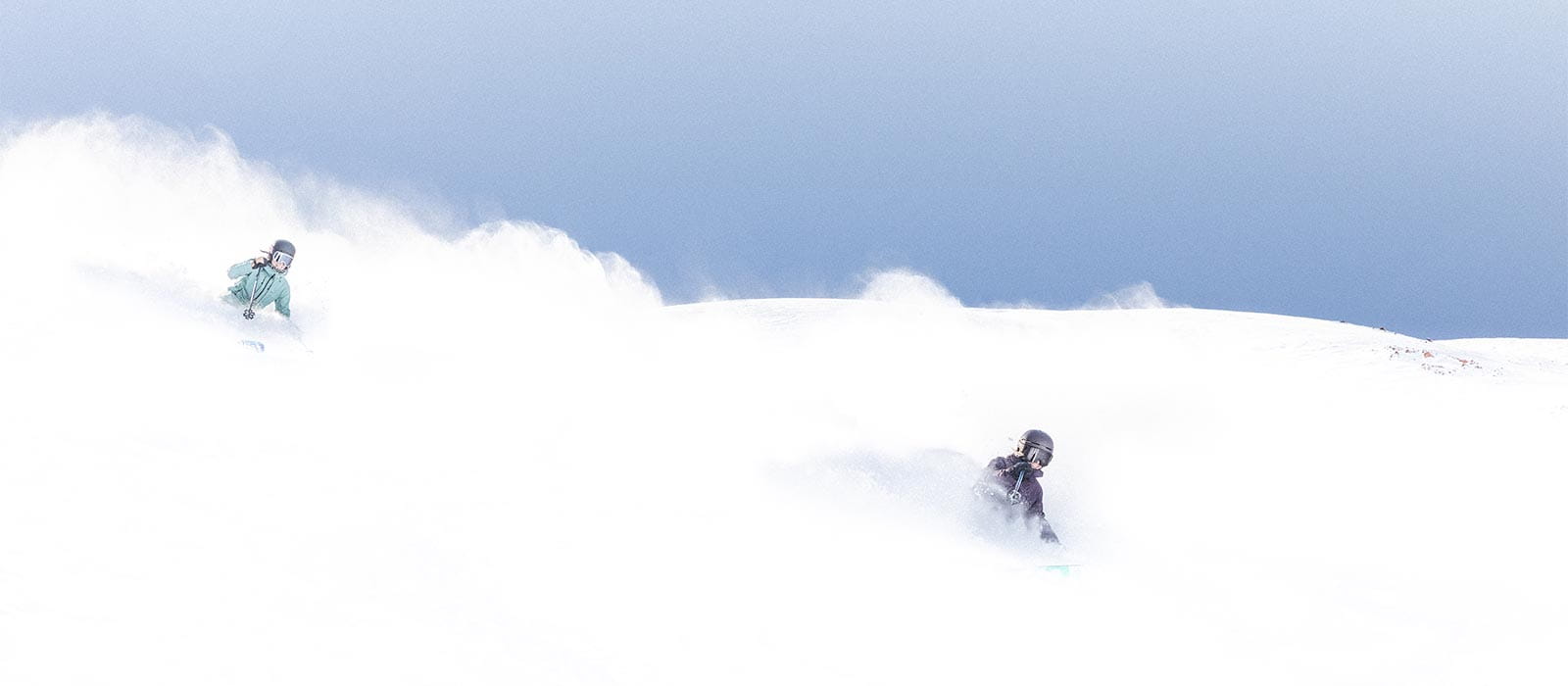Two skiers enjoying a powder day at Aspen Snowmass 