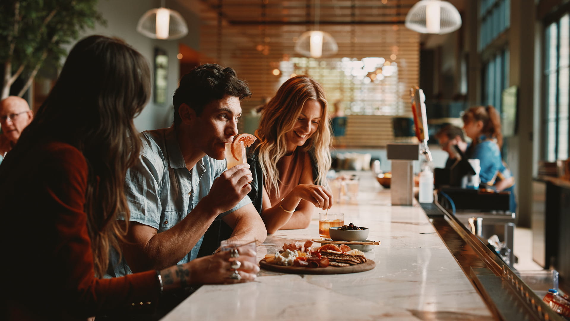 friends at the hotel lobby bar having drinks