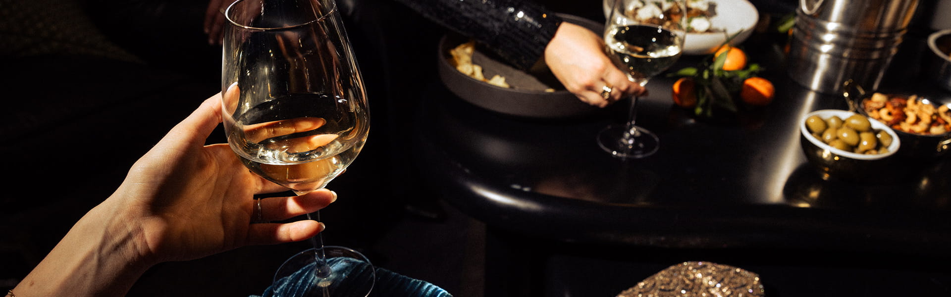person holding wine glass at table